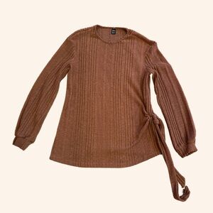 Cozy orange ribbed sweater with a tied siding